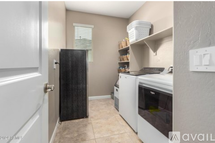 A kitchen with a white oven and a black mat on the floor.
