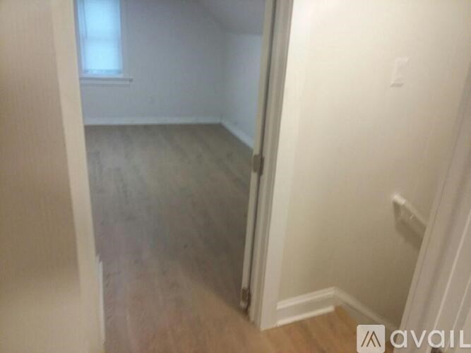 A room with a wooden floor and white walls.