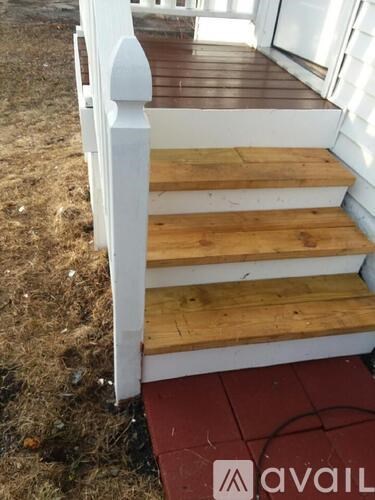 A wooden staircase with a white railing.