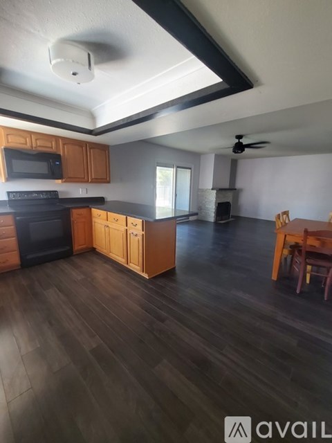A kitchen with wooden cabinets and black appliances.