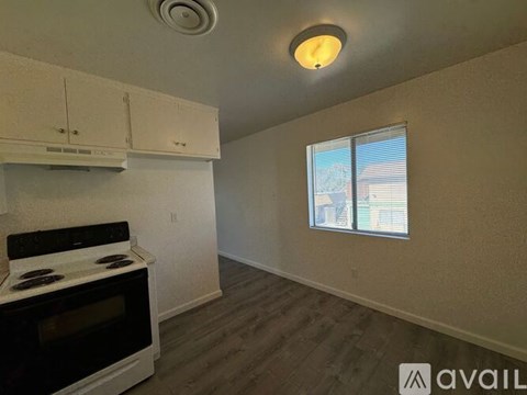 A kitchen with a stove and cabinets is available for rent.
