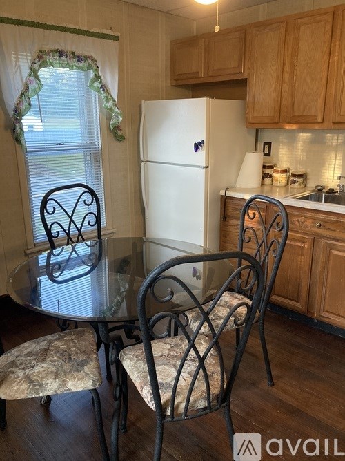 A kitchen with a table and chairs.