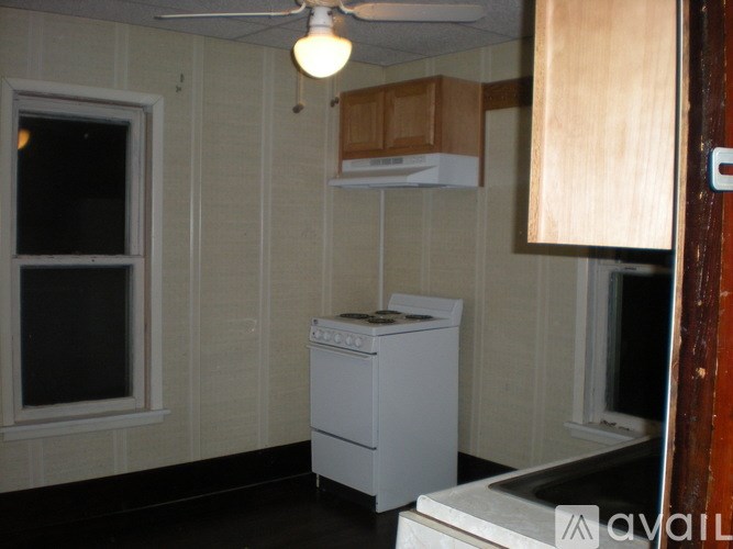 A small room with a washing machine and a window.