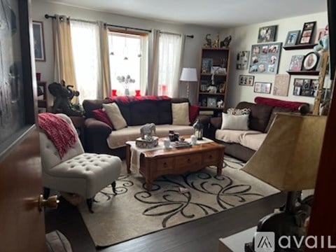 A living room with a white chair and a coffee table.