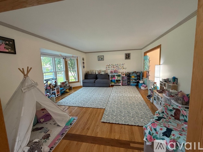 A child's bedroom with a teepee tent and a couch.
