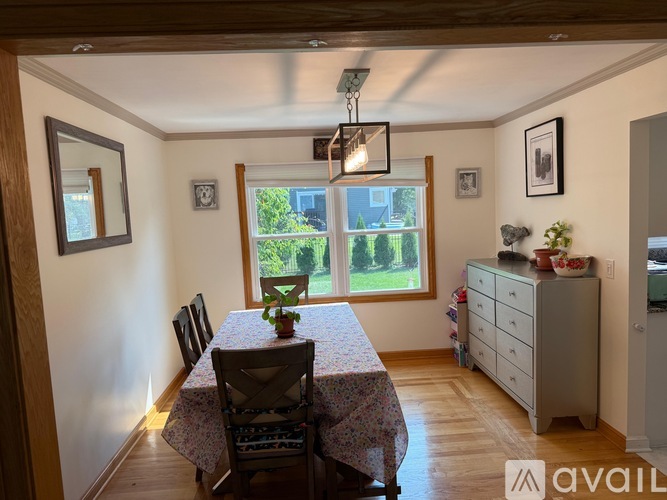 A dining room with a table set for four.