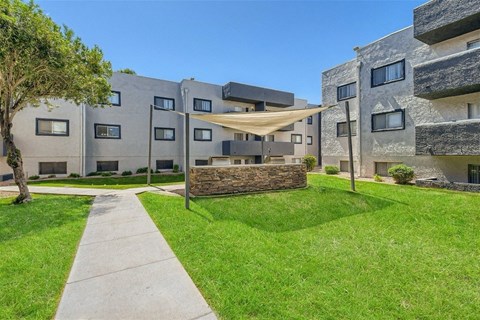 A modern building with a grassy area in front.