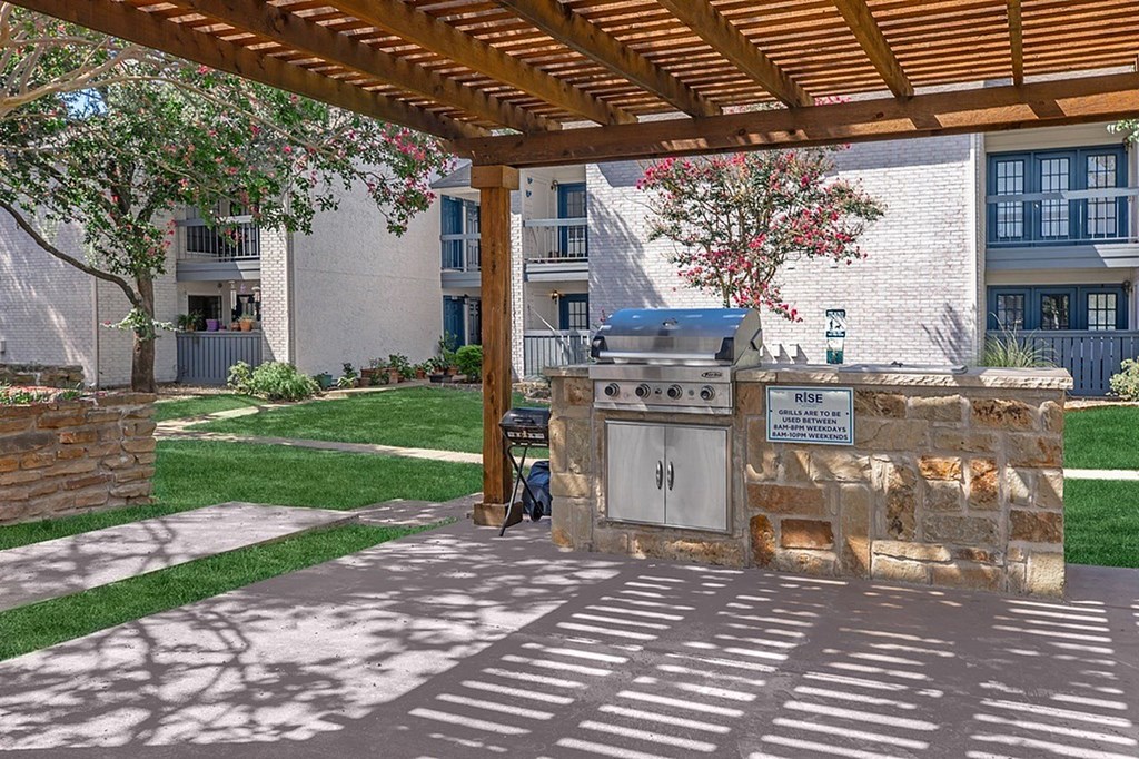 A covered walkway with a sign that says "RISE" on it.