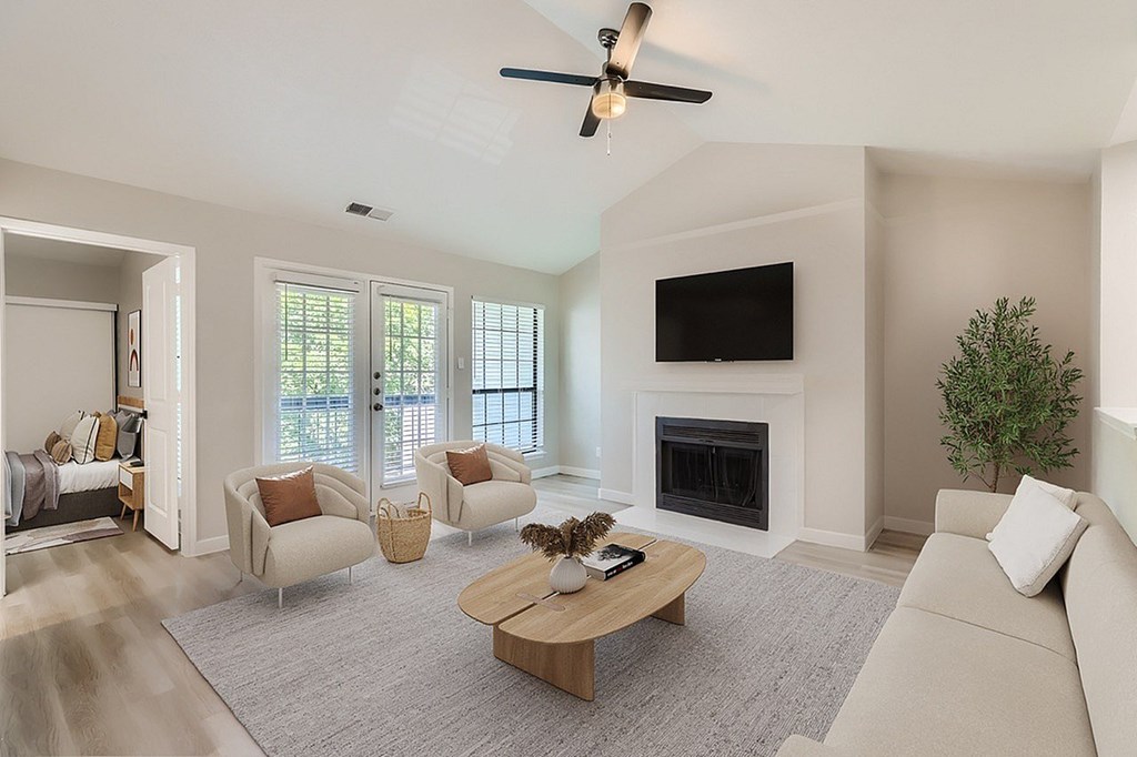 A living room with a fireplace and a television.