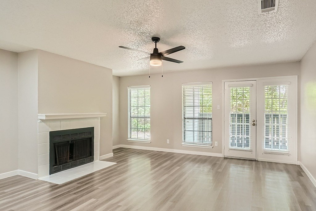 A living room with a fireplace and sliding glass doors.
