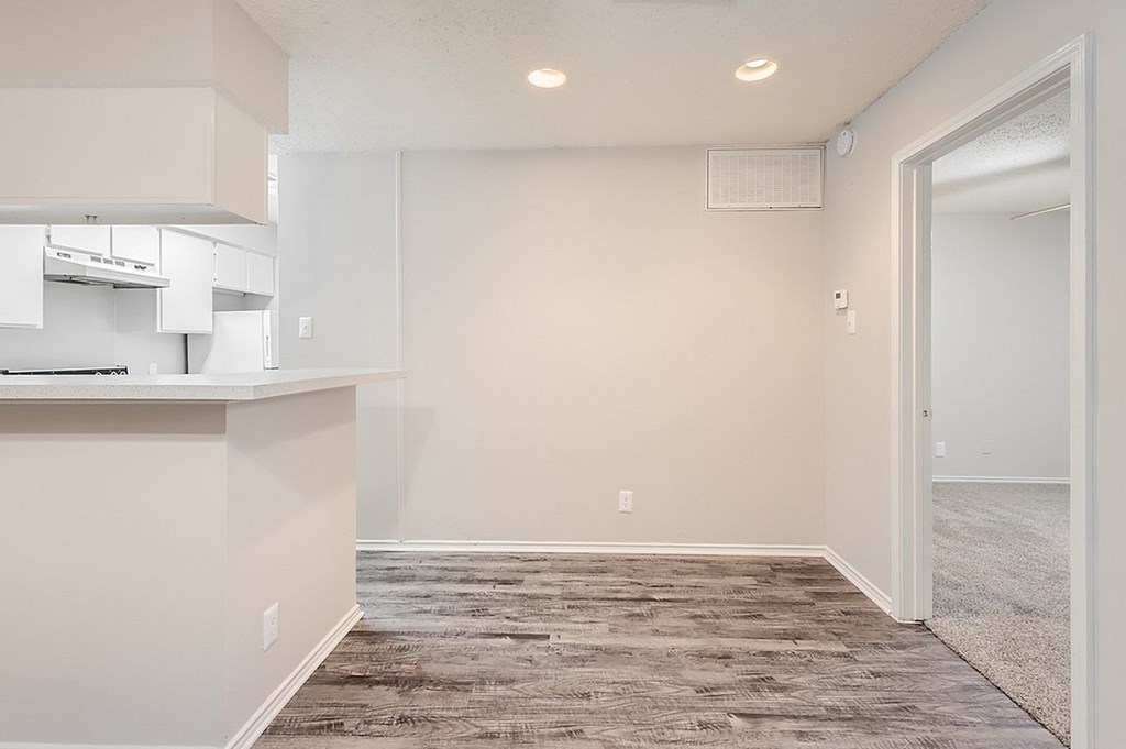 A room with a carpeted floor and a white wall.