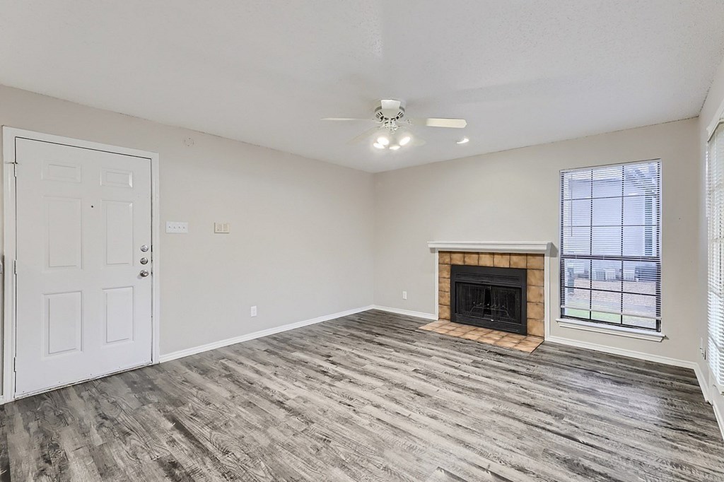 A room with a fireplace and a door.