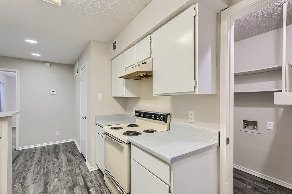 A kitchen with white appliances and cabinets.