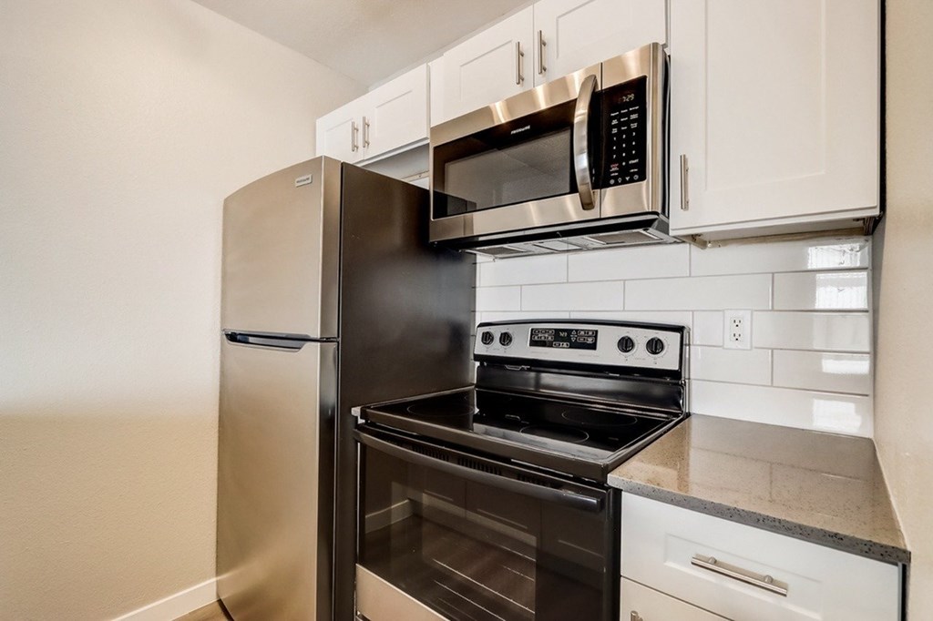 A black stove top oven with a microwave above it.
