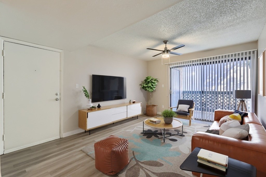 A living room with a television, a couch, and a coffee table.