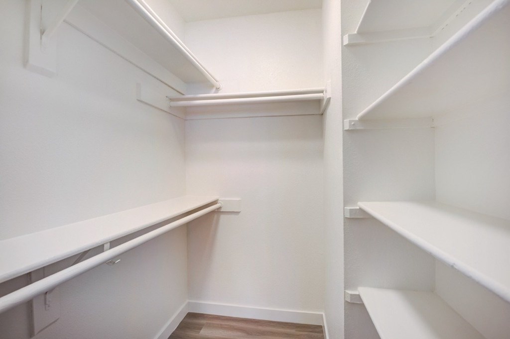 Empty white shelves in a room.