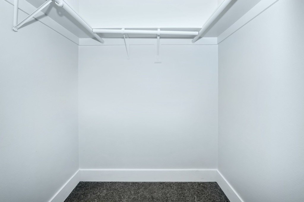 A white room with a grey carpet and a white ceiling.