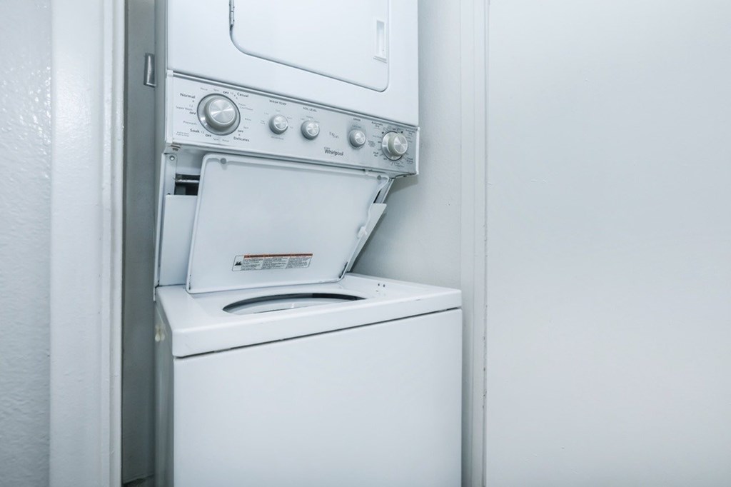 A white dishwasher with a control panel on top.