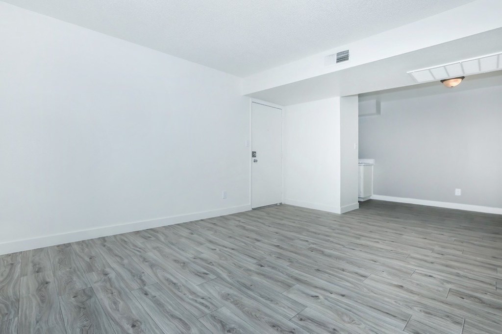 A room with a grey floor and white walls.