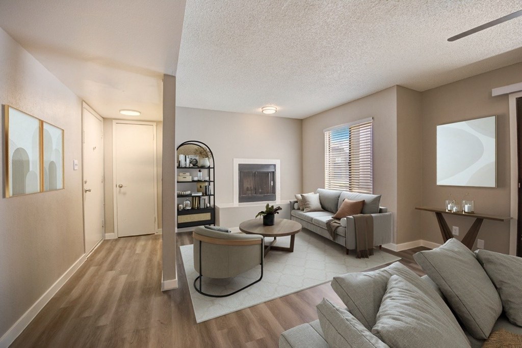 A living room with a grey couch and a coffee table.