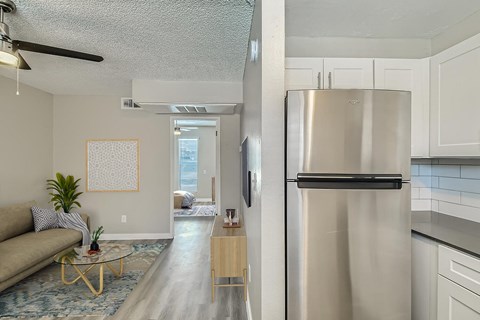 A kitchen with white cabinets and a black oven.