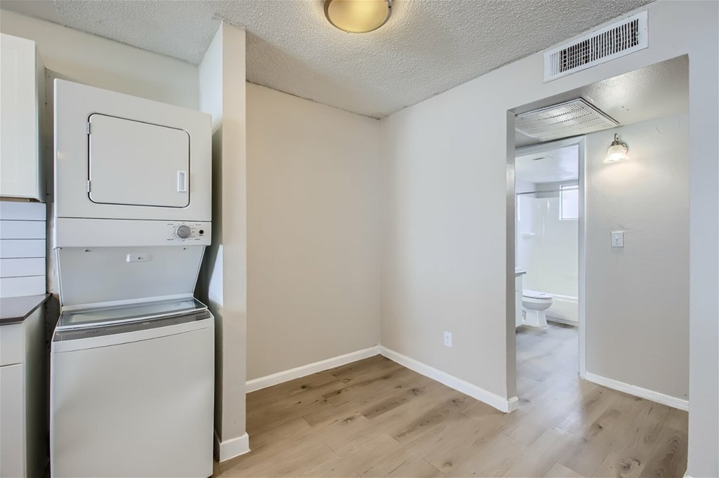A small laundry room with a washer and dryer.