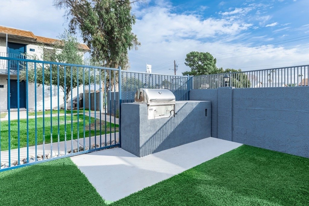 A blue fence surrounds a small garden area.
