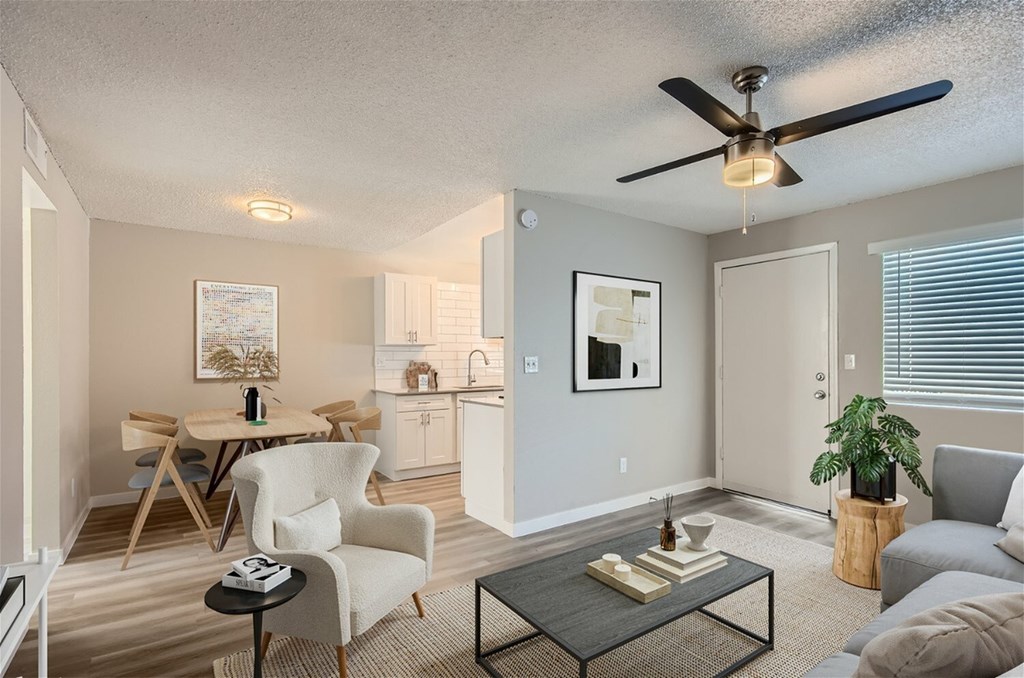 A living room with a dining table and chairs.