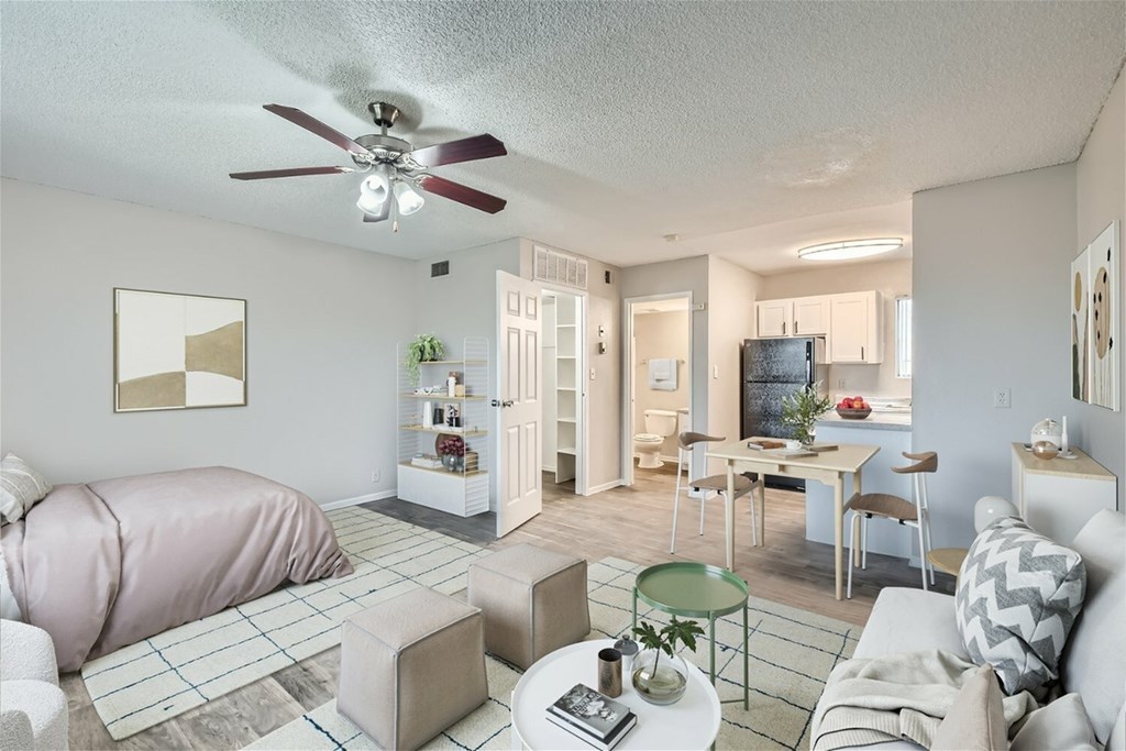 A living room with a pink sofa and a green glass table.