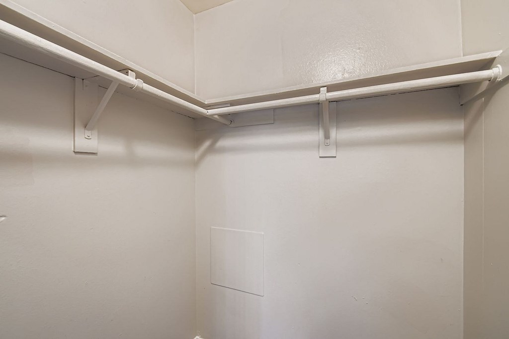 A room with a ceiling fan and tile flooring.