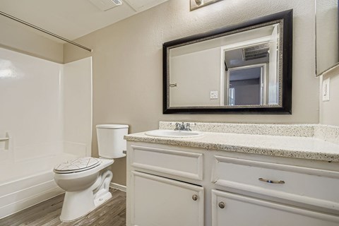 A spacious room with a ceiling fan and tile flooring.