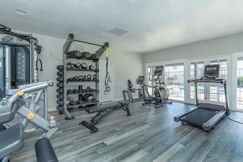 A spacious home gym with a variety of exercise equipment.