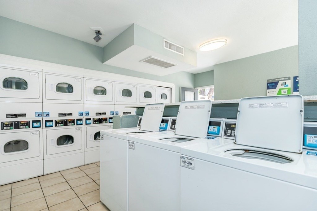 A row of washing machines in a laundromat.