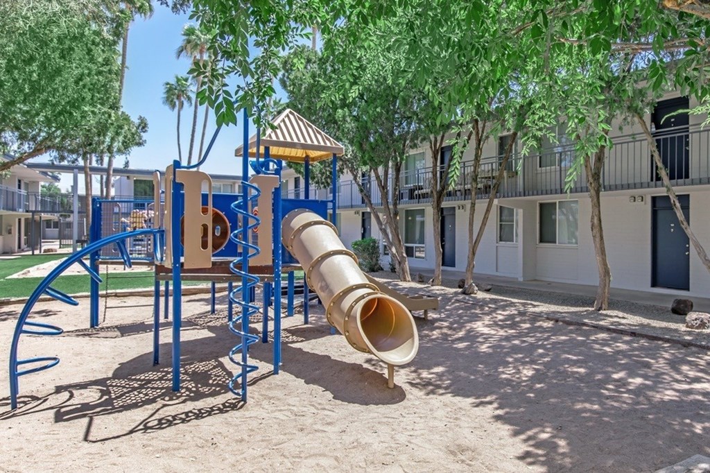 A playground with a slide and a sandbox.