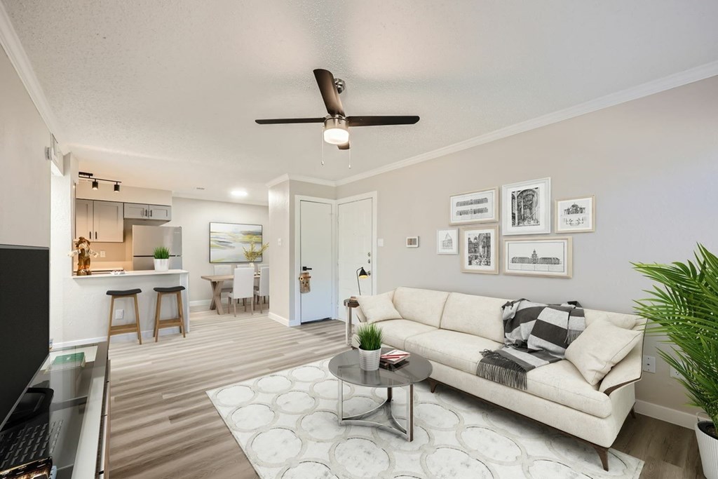 A living room with a couch, coffee table, and pictures on the wall.