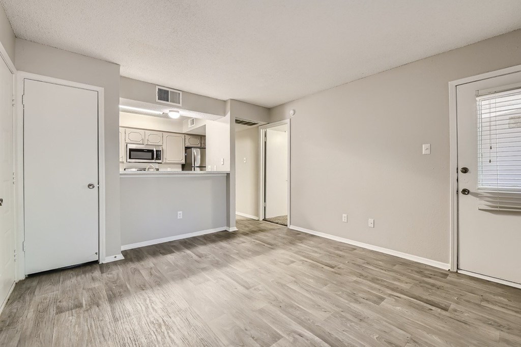 A kitchen area with a microwave, oven, and refrigerator.
