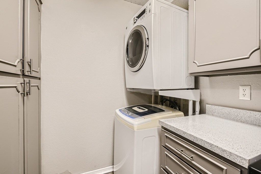 A white washing machine and dryer in a laundry room.