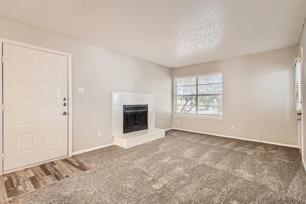 A room with a fireplace and a door.