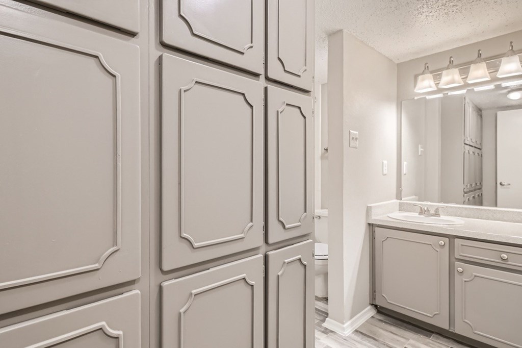 A bathroom with a vanity and a mirror.