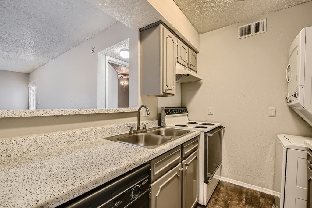 A small kitchen with a sink, stove, and oven.