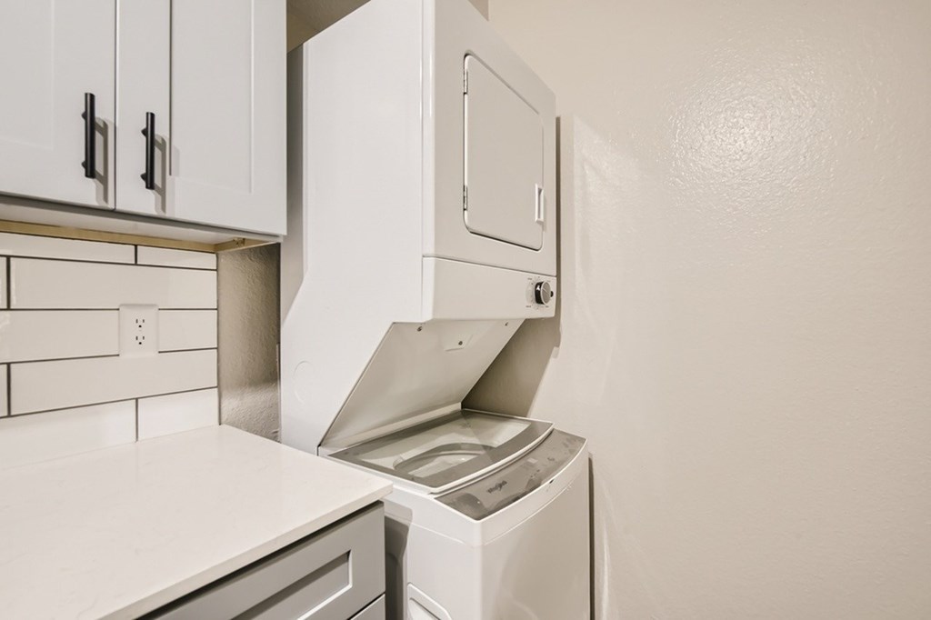 A white dishwasher is in a kitchen.