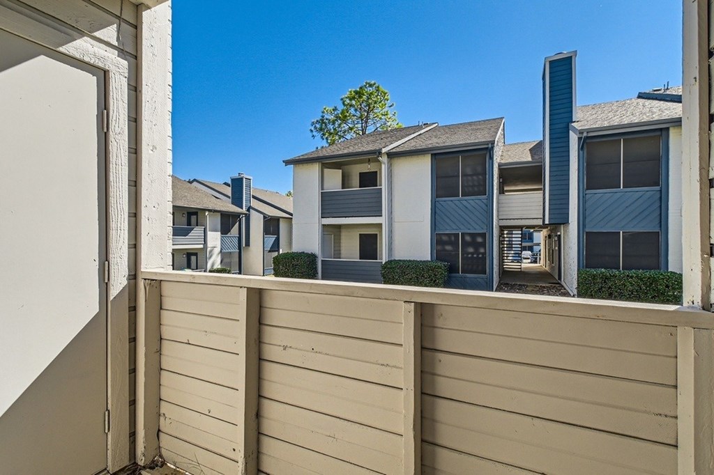 A row of modern houses with a clear blue sky above them.