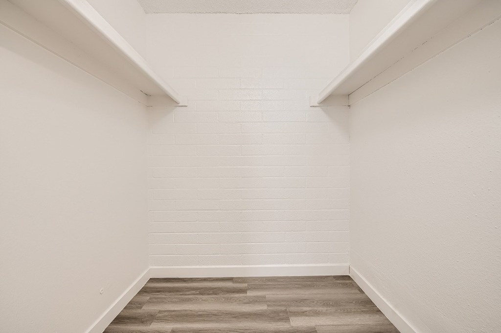 A room with white walls and a wooden floor.