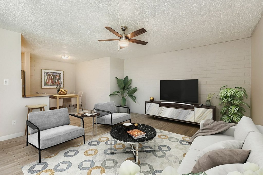 A modern living room with a grey couch and a black chair.