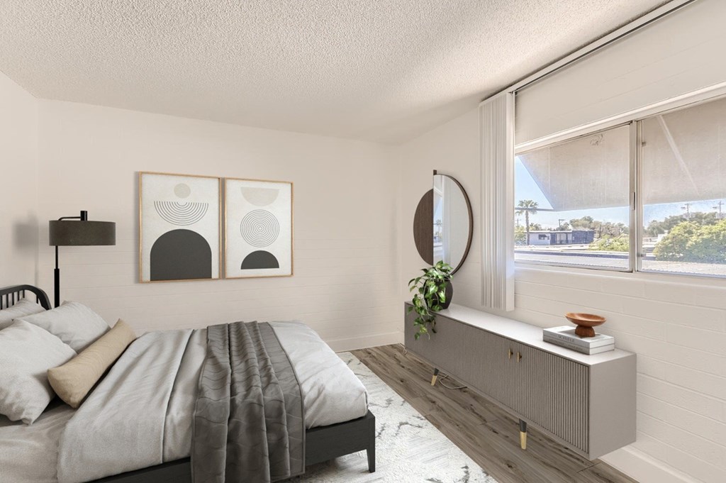 A bedroom with a bed, nightstand, and two framed pictures on the wall.