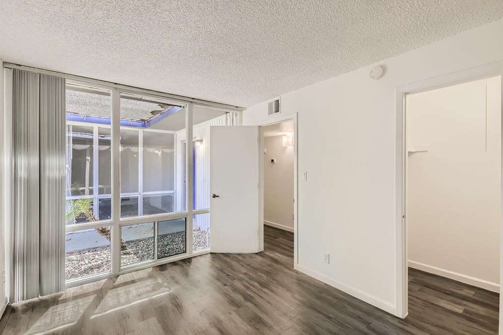 A room with a sliding glass door leading to a patio.