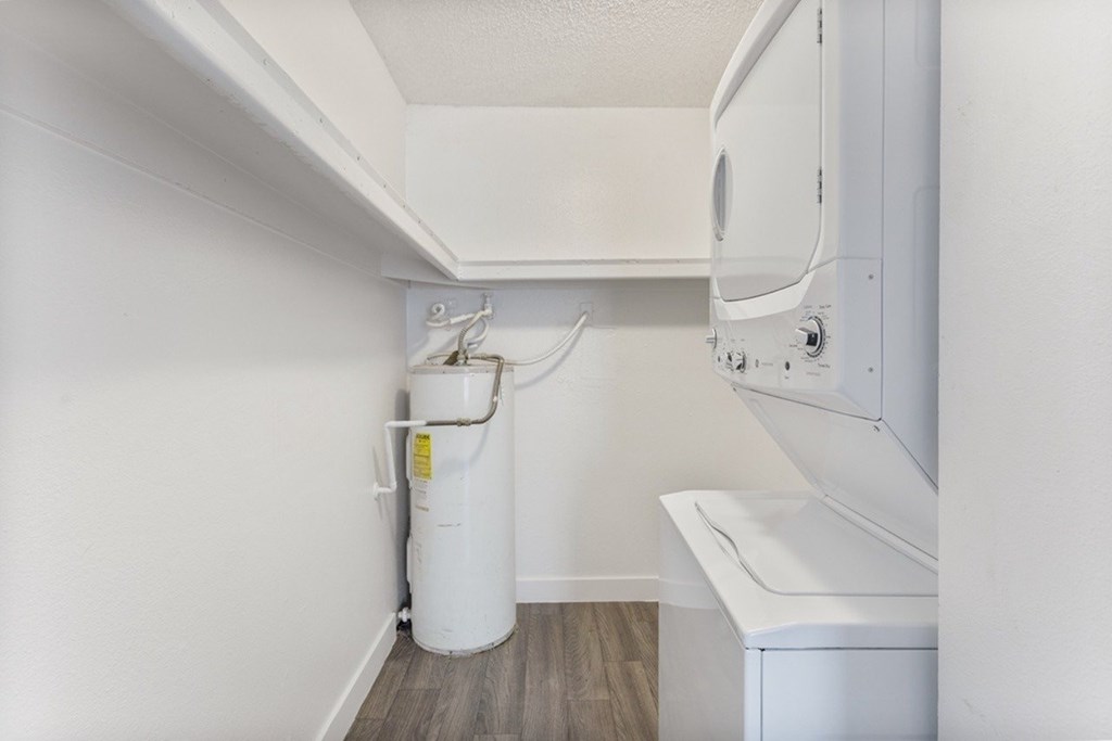 A white washing machine is in a small laundry room.