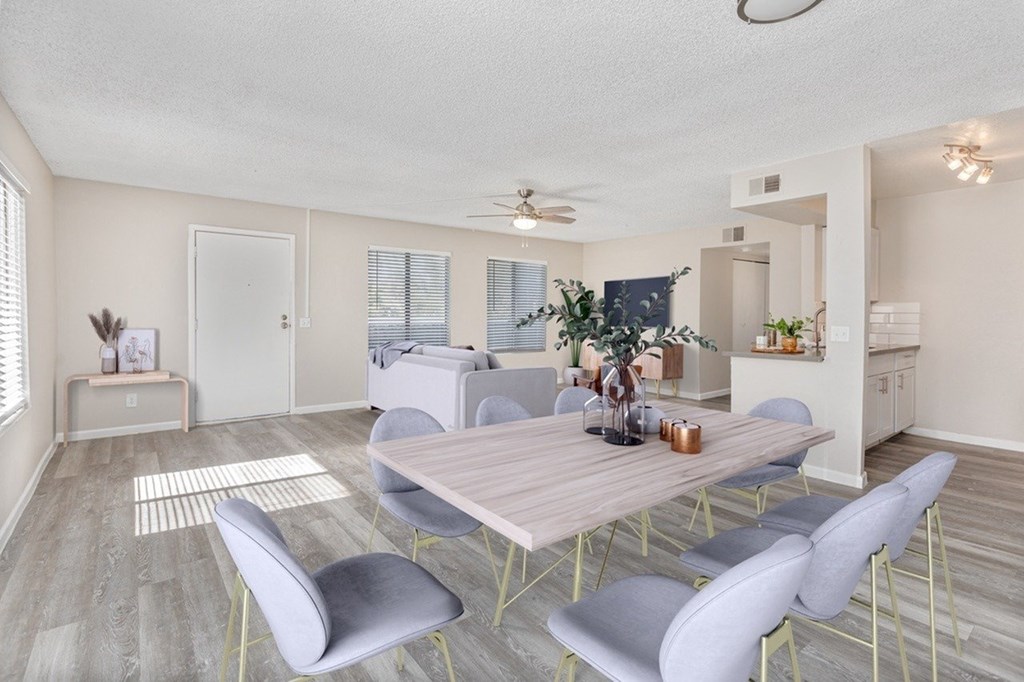 A dining room with a table and chairs.