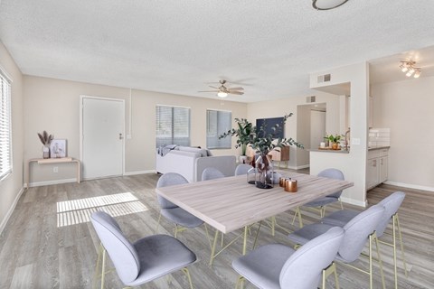 A dining room with a table and chairs.