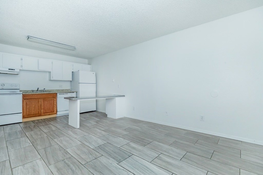 A kitchen with a wooden island and a bench.